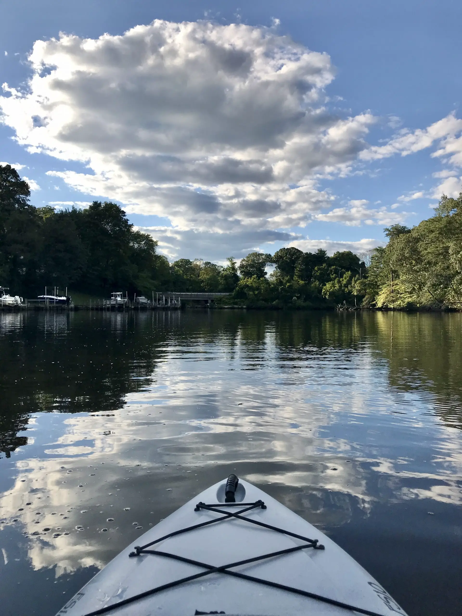 kayak tip on river with blue skies