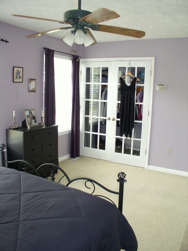 Purple bedroom with white French closet doors