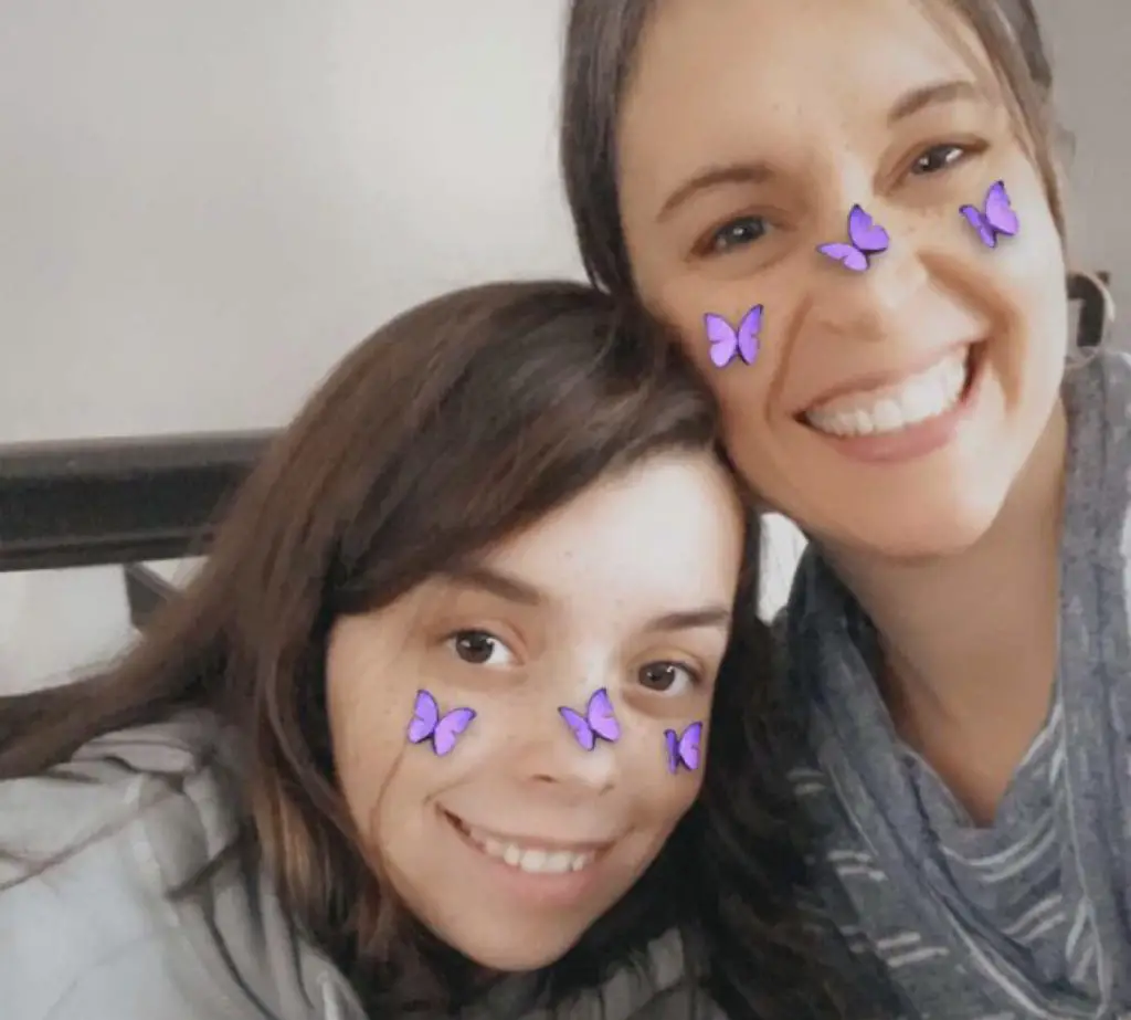 Kristen and Lisey with butterflies on their cheeks.