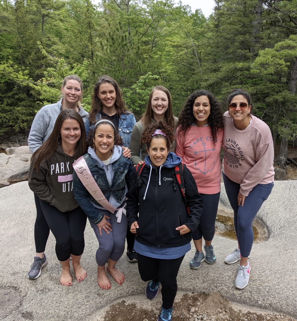 A group of women hiking in the woods.