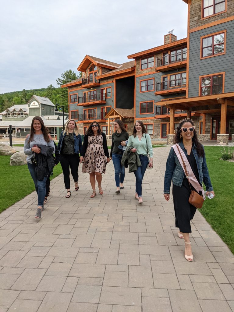 A group of women walking down a stone walkway.