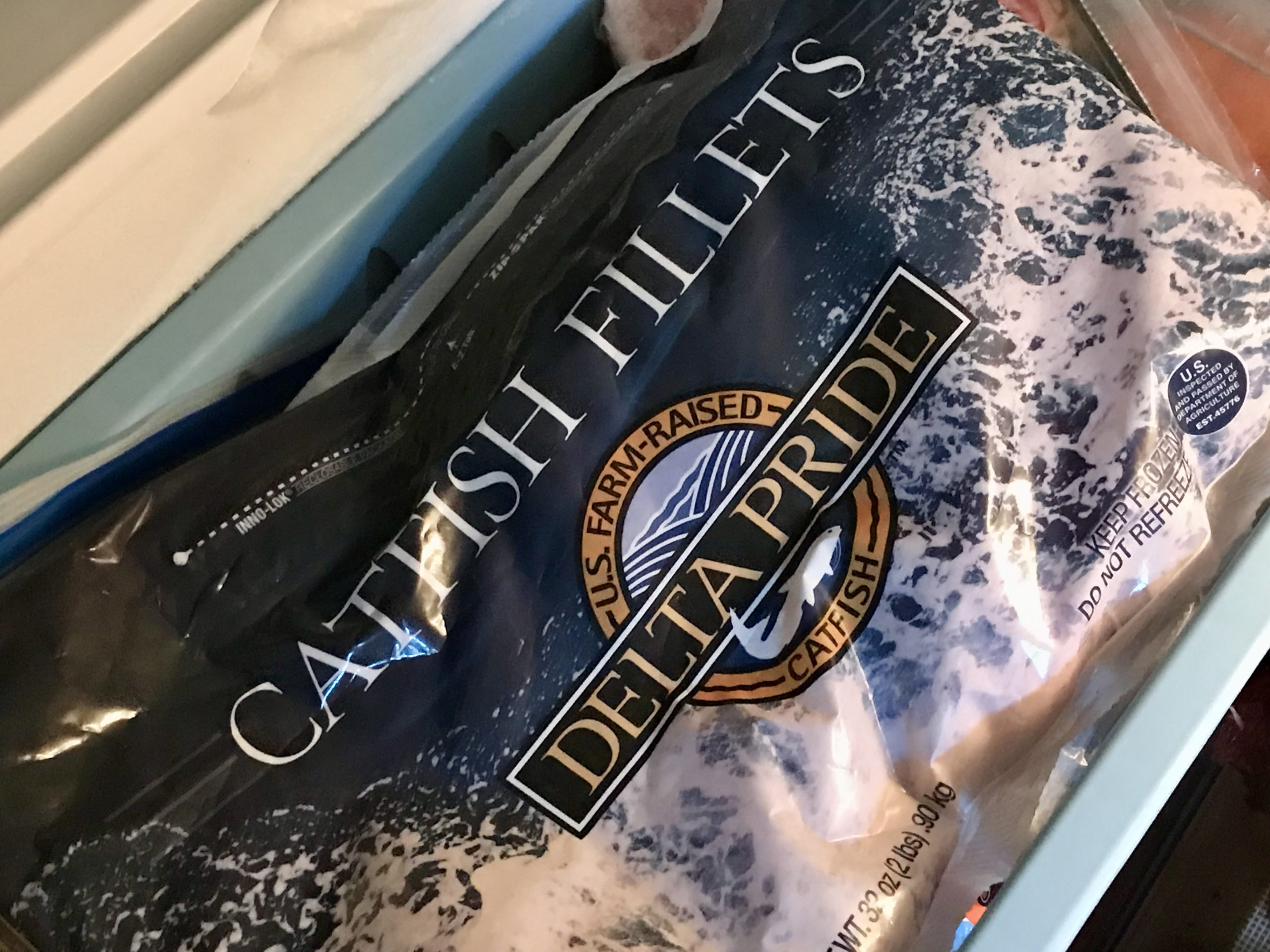 A bag of frozen catfish fillets.