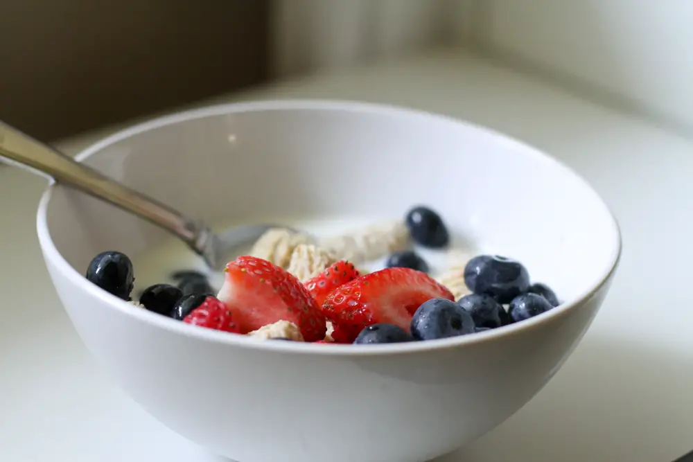bowl of cereal topped with fruit.